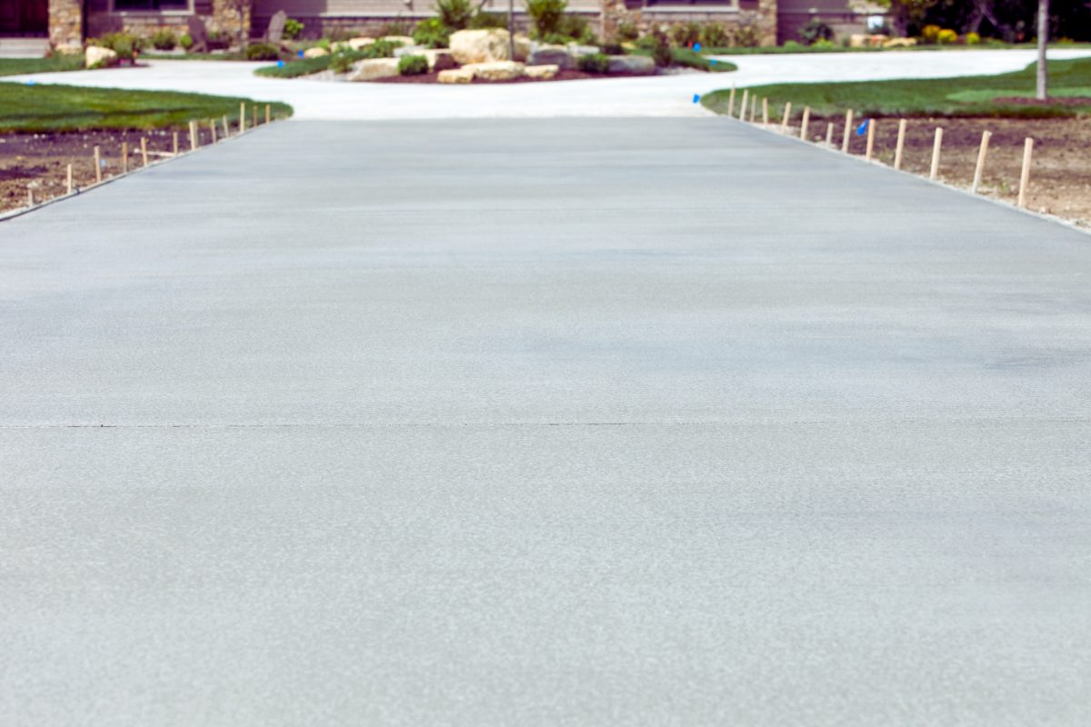 Freshly poured plain grey concrete driveway